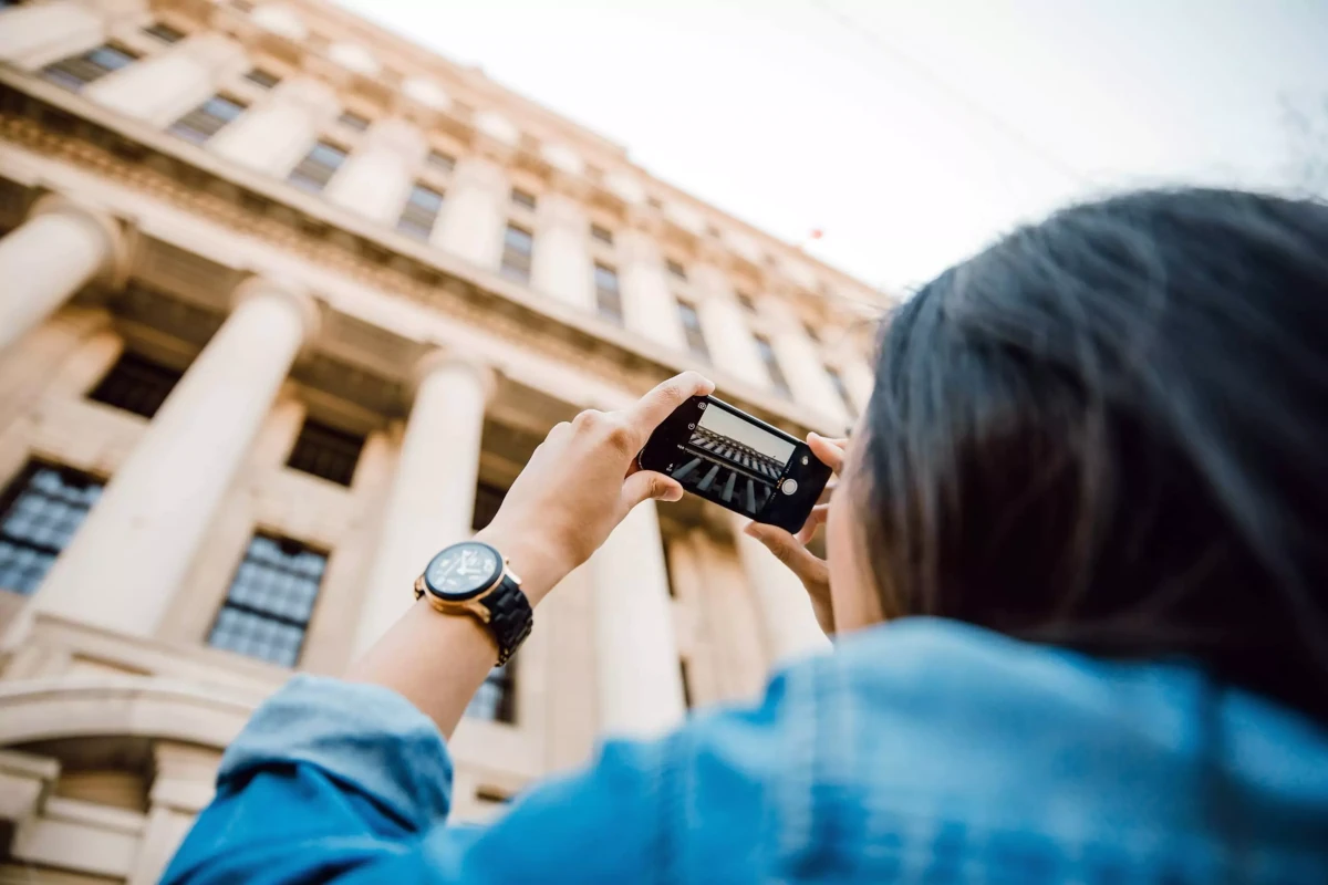 About Tourist taking photo of a building